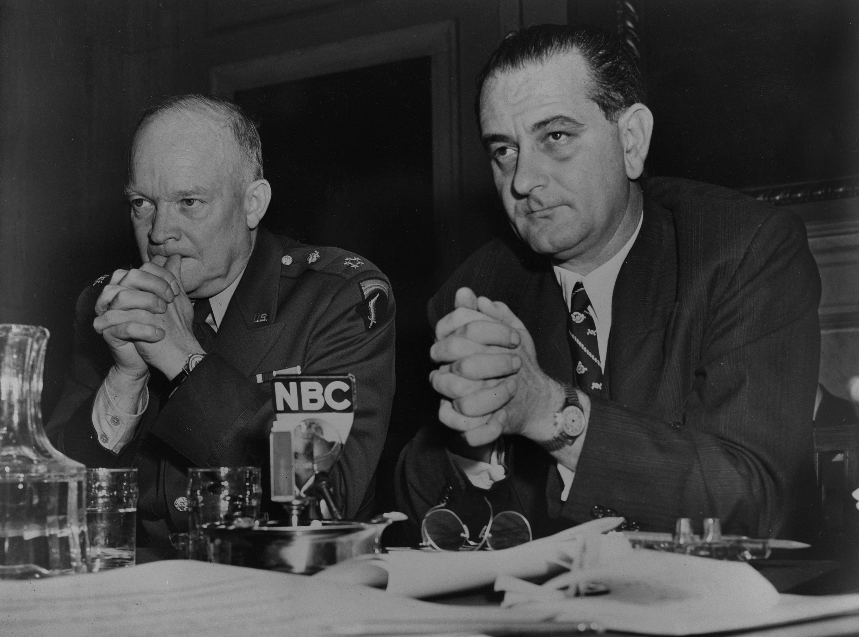 General Dwight D. Eisenhower, in uniform, and LBJ sit behind an NBC microphone at a table.